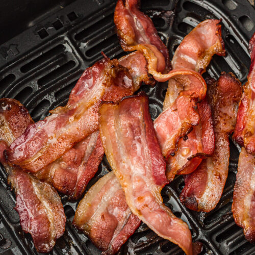 Crispy bacon sizzles to perfection in the air fryer basket, bringing out its irresistible flavor and crunch.