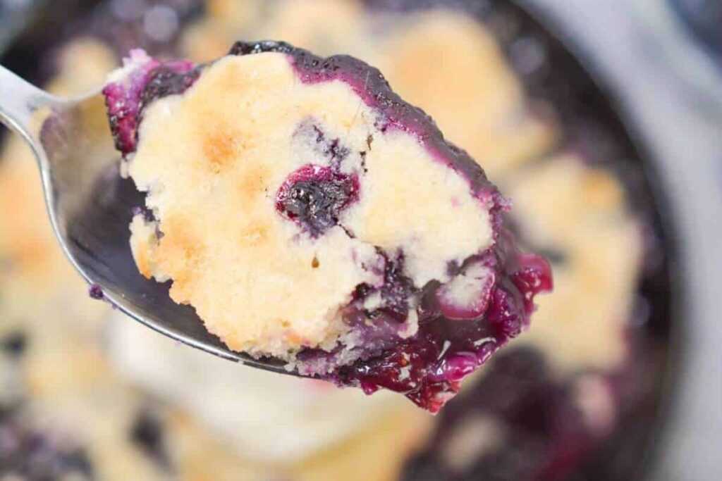 A spoonful of Fruity Delights reveals a golden brown crust and a lush layer of blueberries, hitting every sweet note.